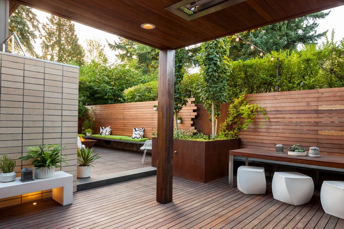 An outdoor kitchen beside a planted terrace