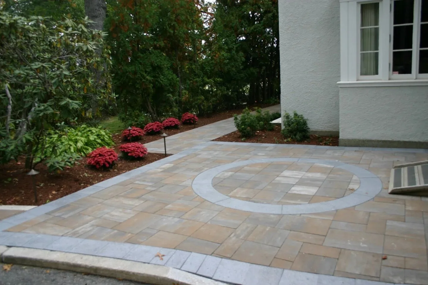 Circular paving inset beside the house.