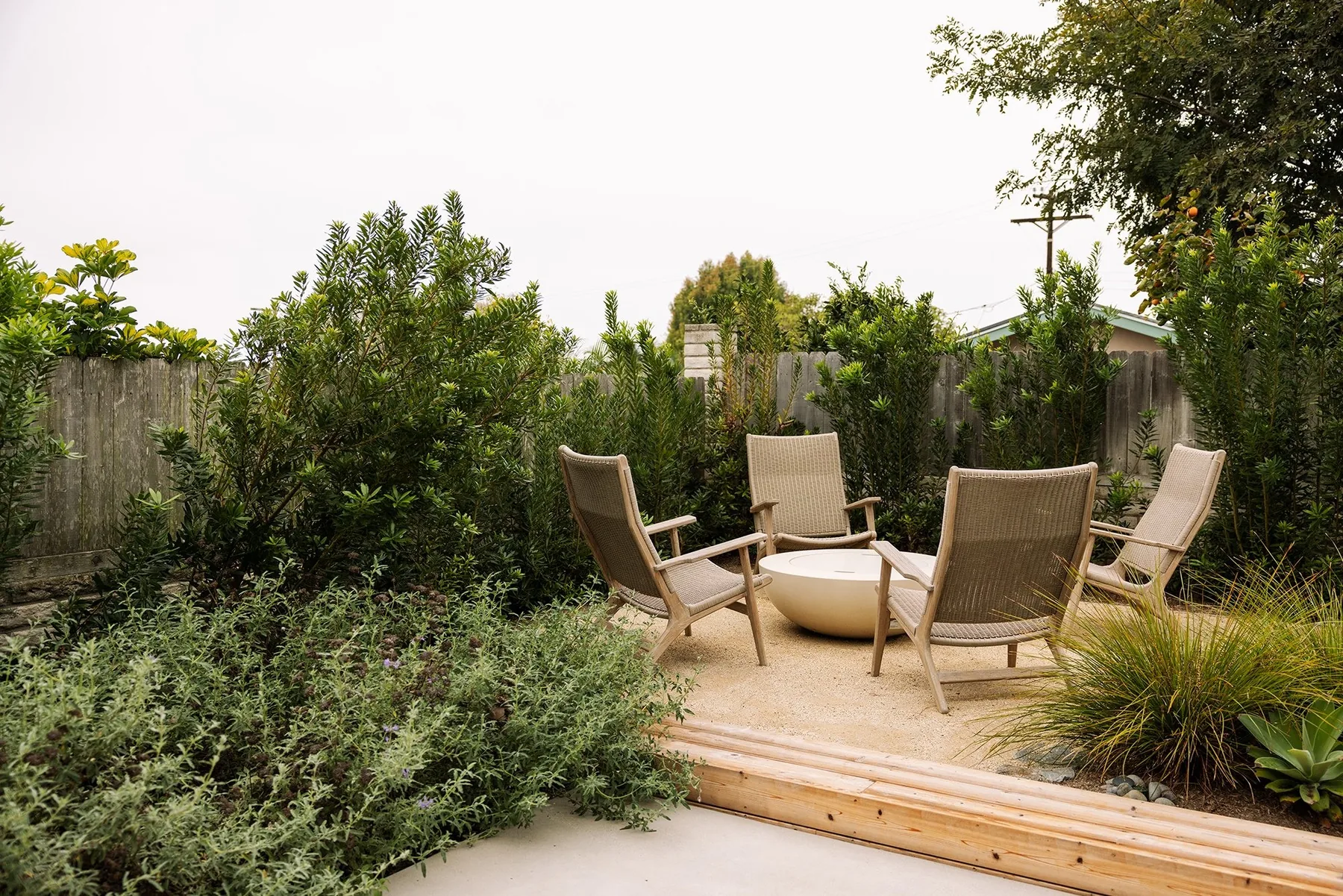 Chairs on a small terrace reached by timber steps.