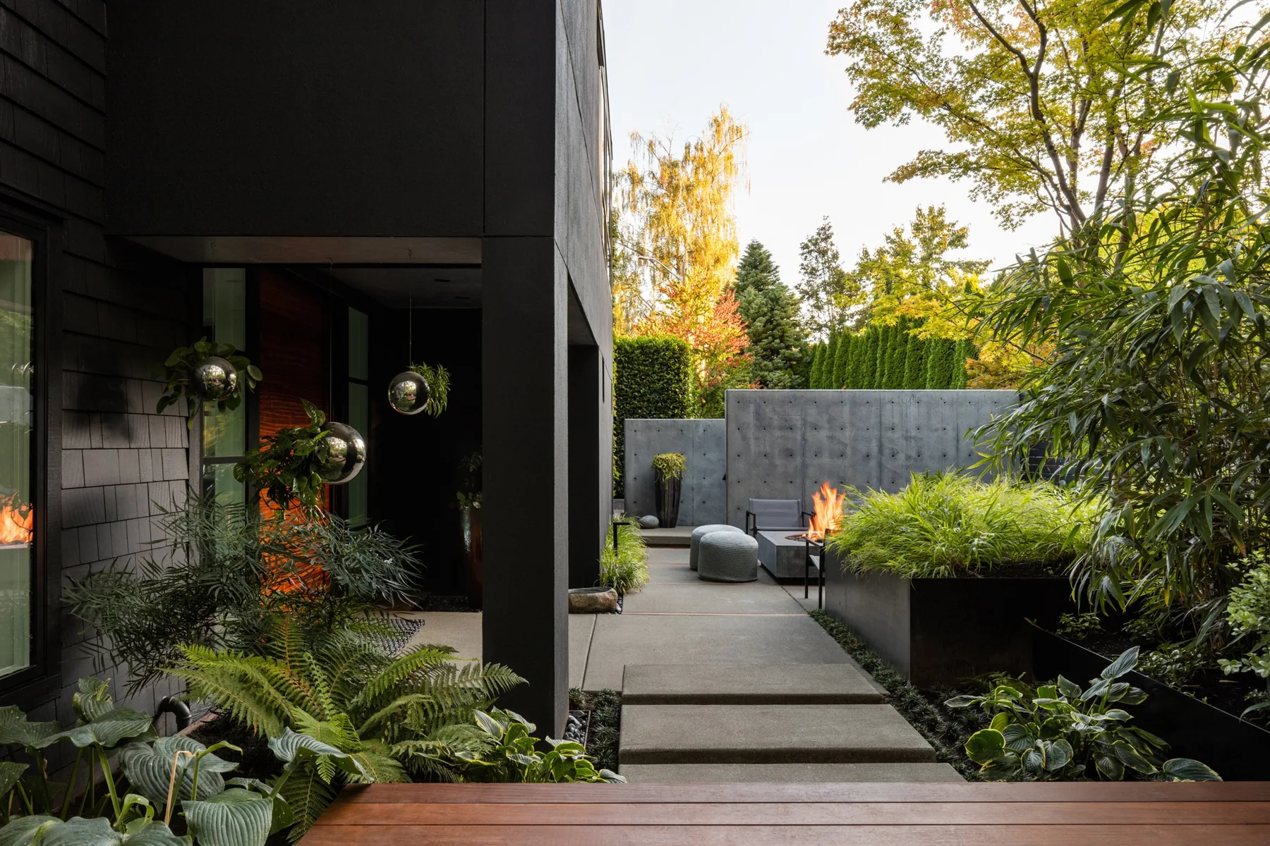 Entry path beside raised steel planters in the Bento courtyard.