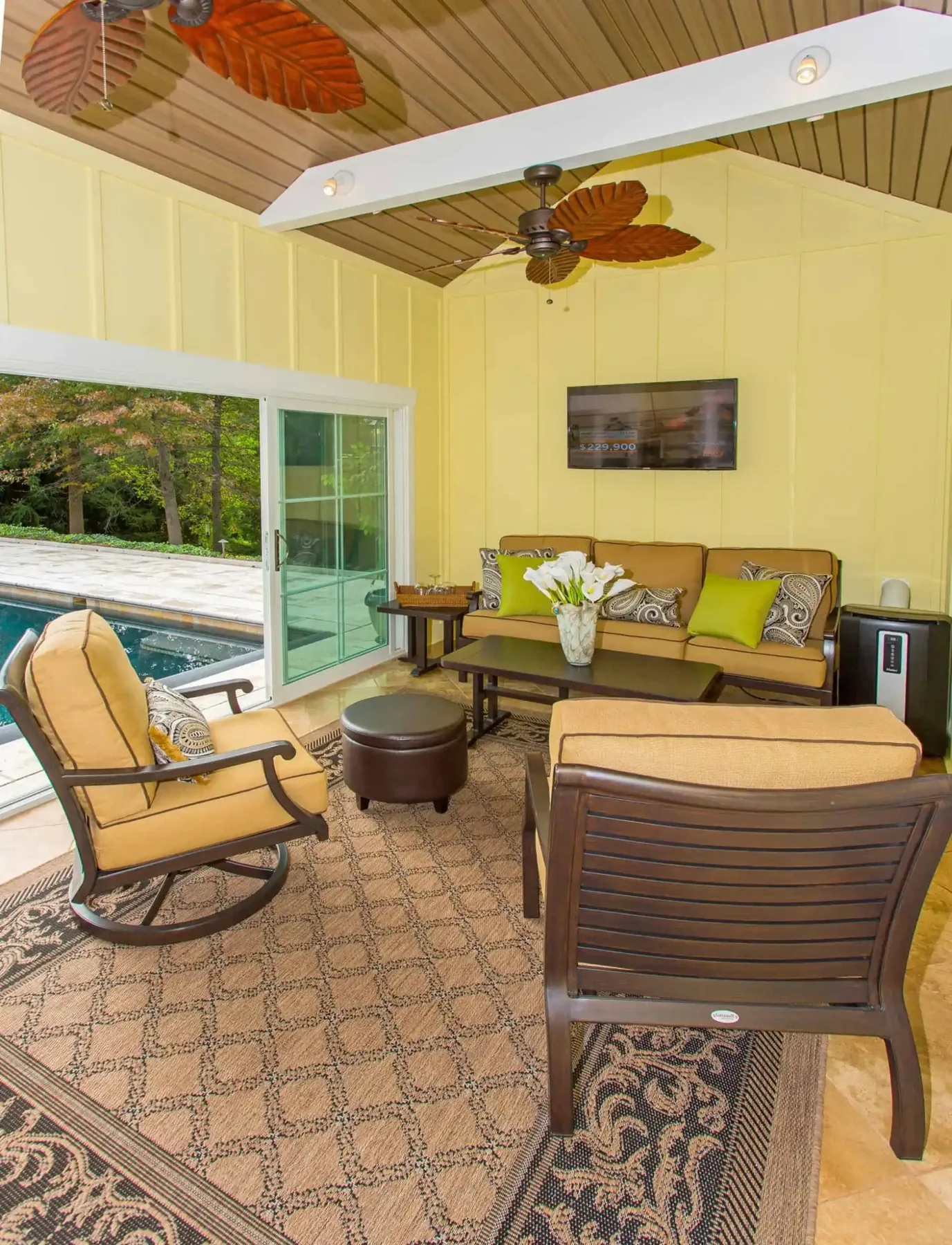 Seating inside the pool house facing wide glass doors.