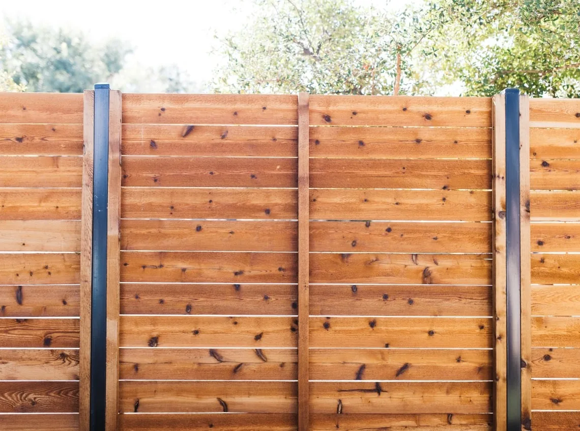 Close view of horizontal boards and exposed metal posts.