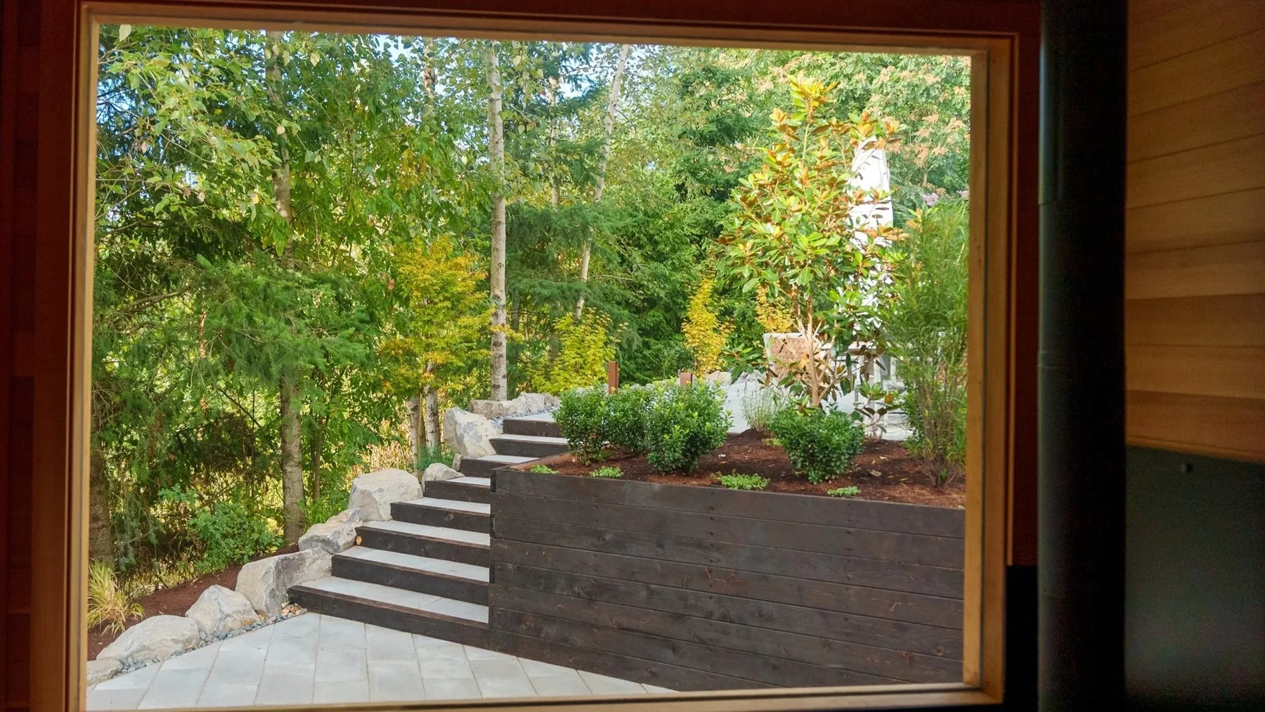 View from the sauna toward planted steps.