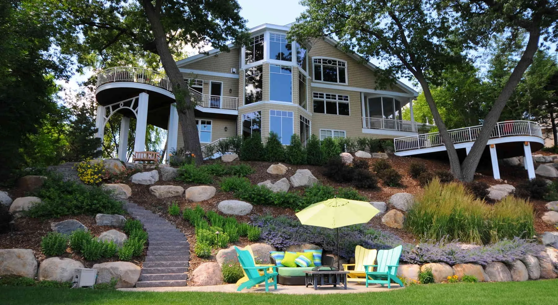 Closer view of boulders and planted terraces below the house.