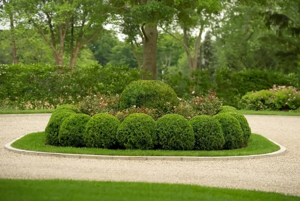 Planted island within a curving gravel drive.