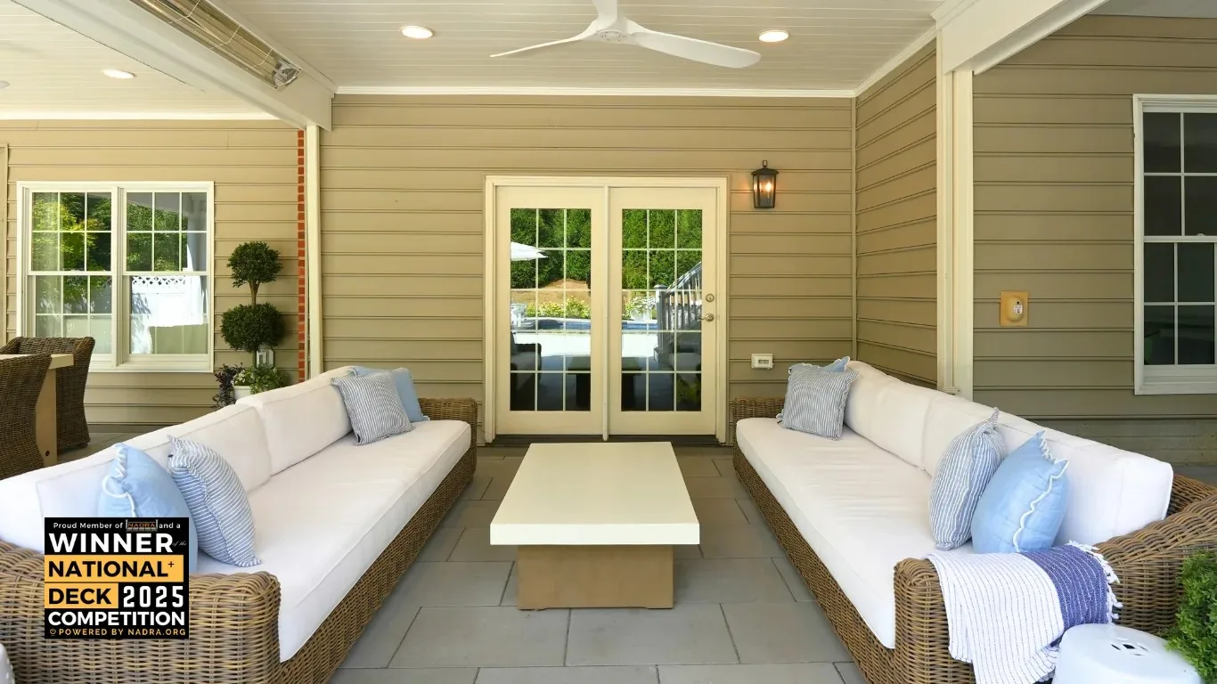 Covered seating area with pale sofas.