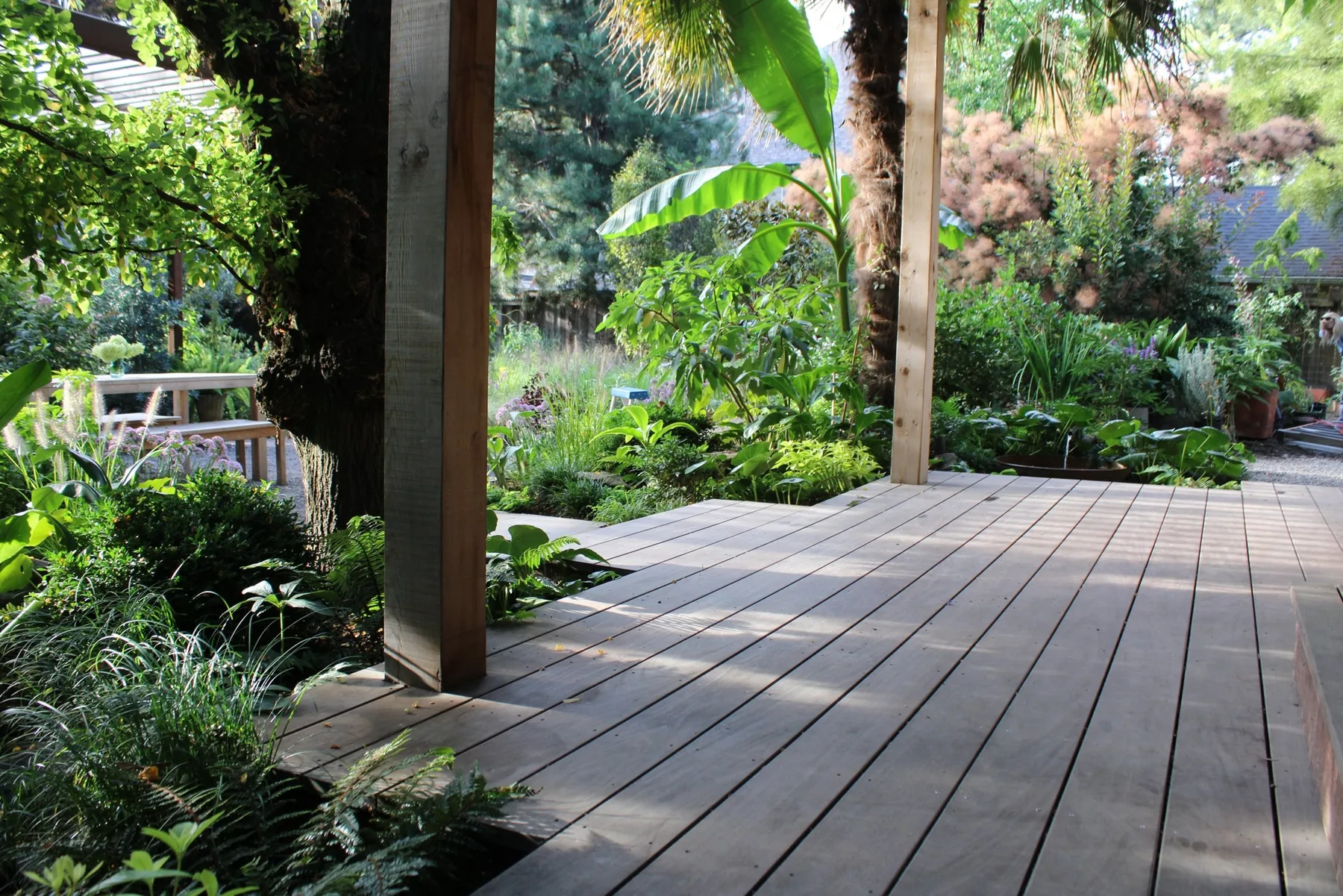 Ipe porch deck opening into lush garden planting.