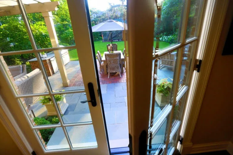 View through French doors onto the outdoor dining area.
