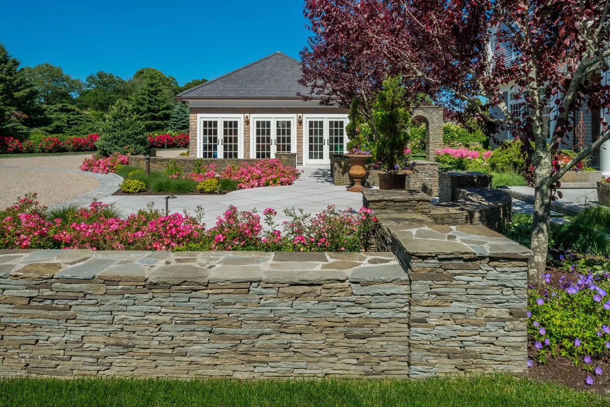 Restored fieldstone wall beside the garden.