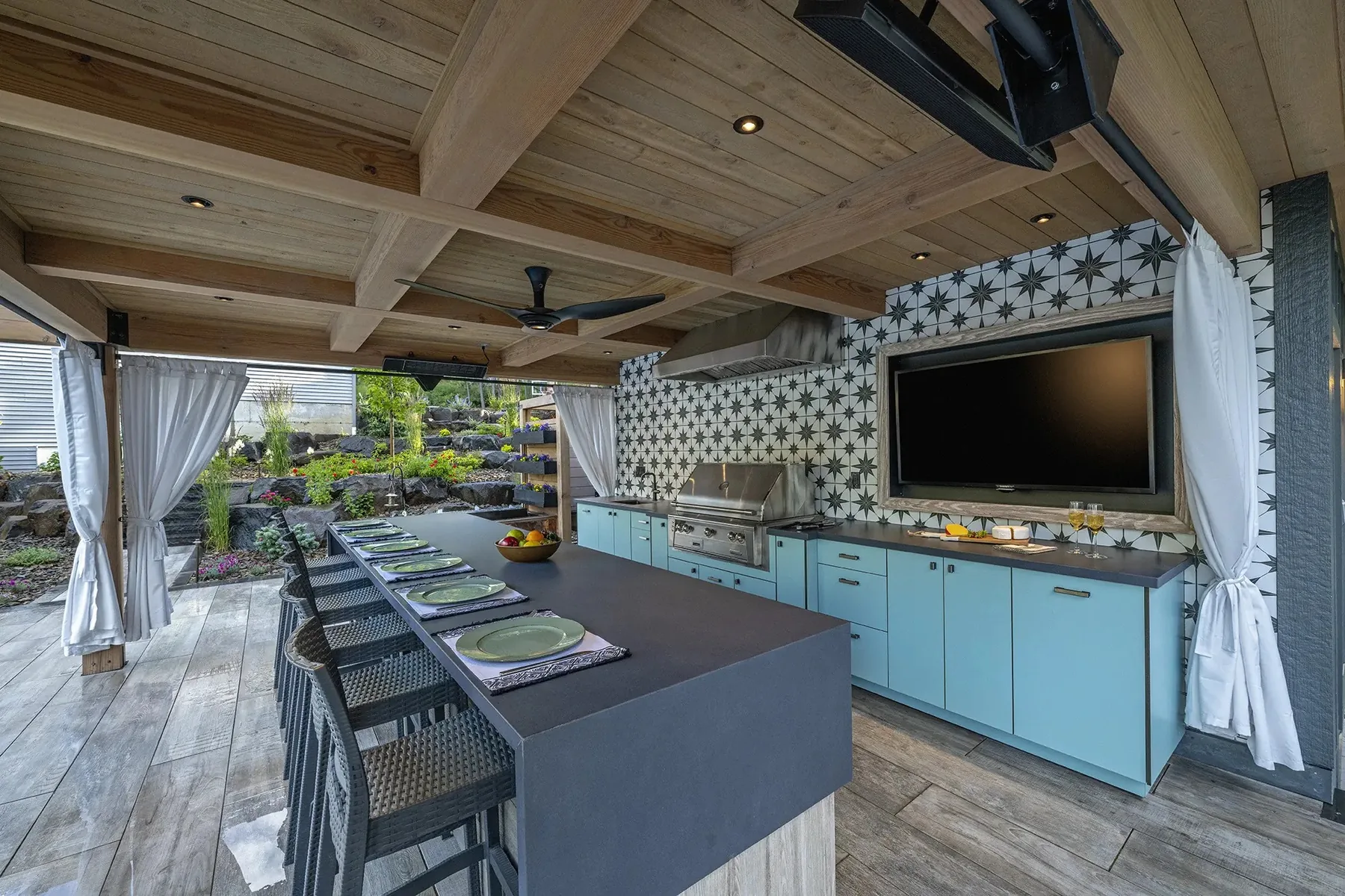 Covered kitchen with a long counter and patterned tile.