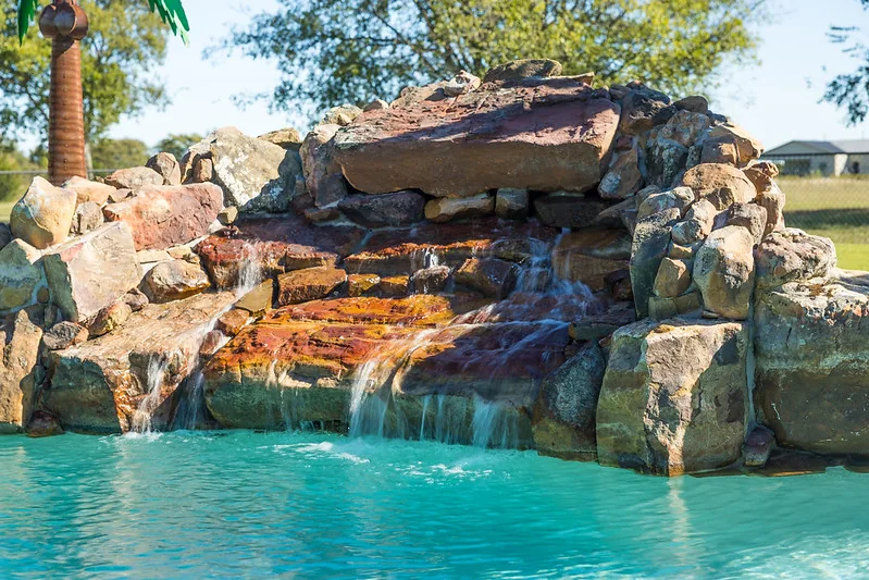 The freeform pool meets textured stone and planting.