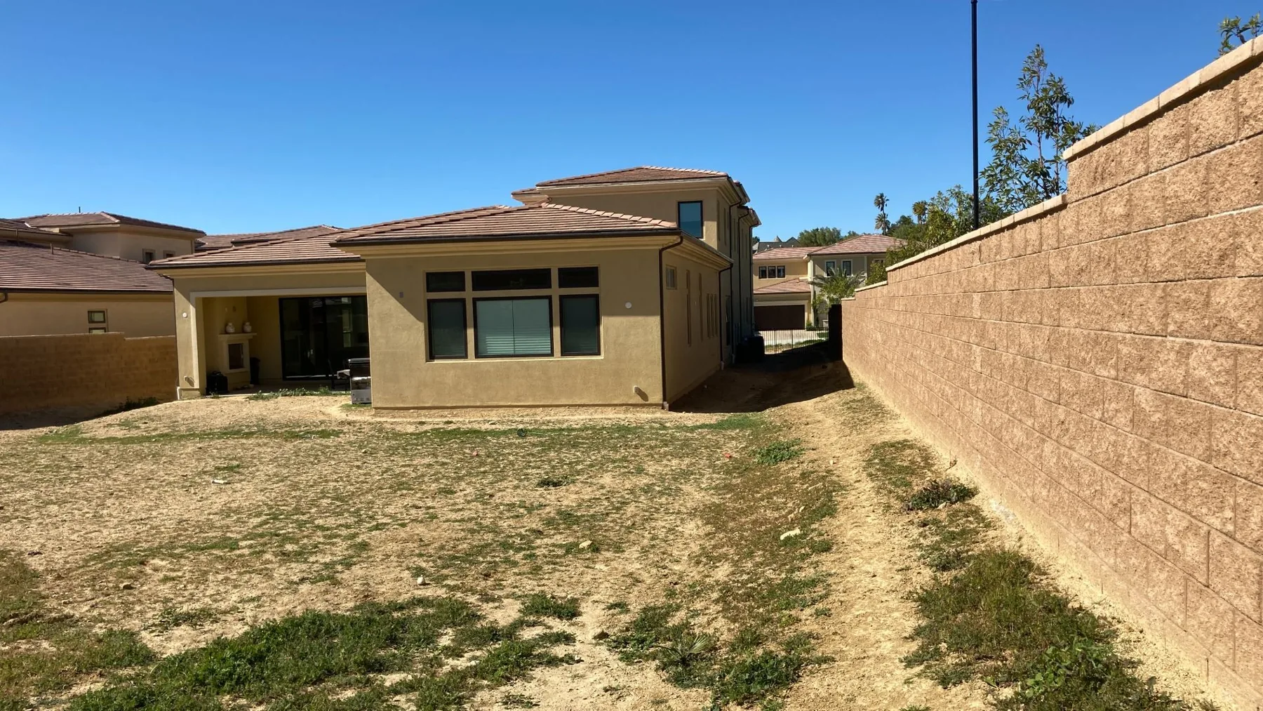 Unfinished yard before the pool and outdoor rooms were built.