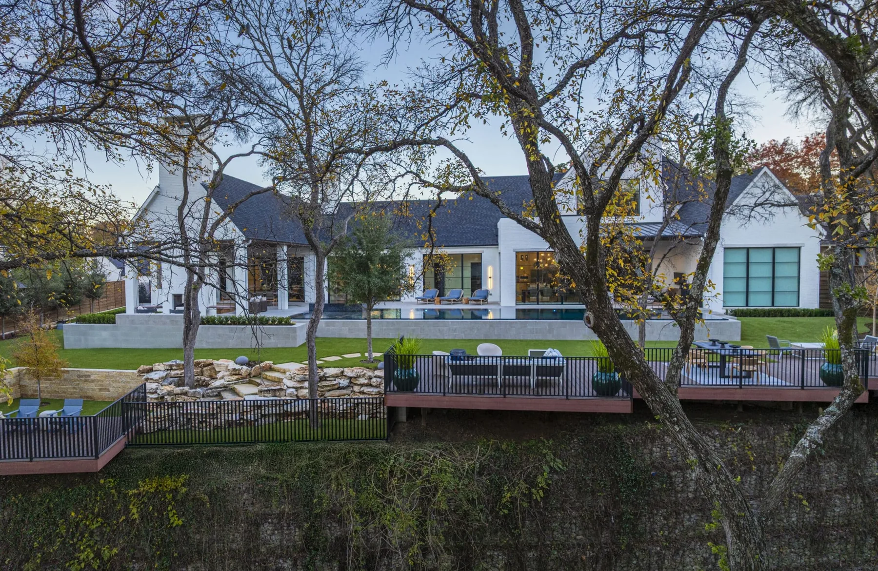 Creek-side deck beneath existing trees.