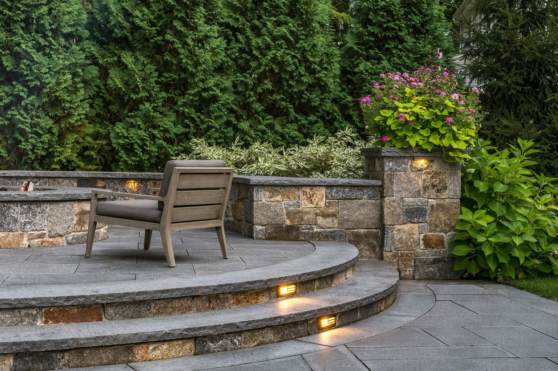 Curved stone steps with integrated lighting.