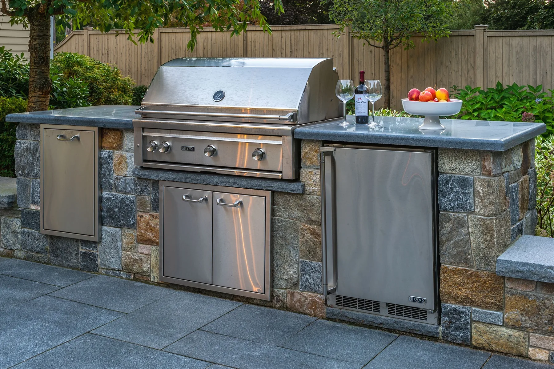 Grill and kitchen counter faced in stone.
