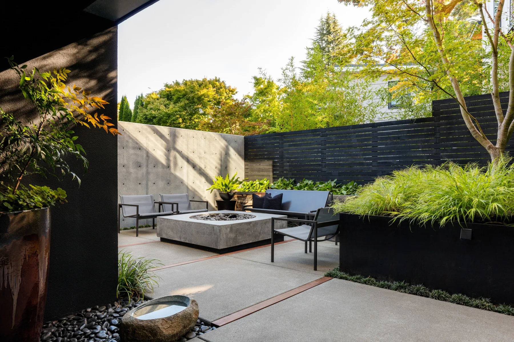 Concrete fire feature and seating in the Bento courtyard.