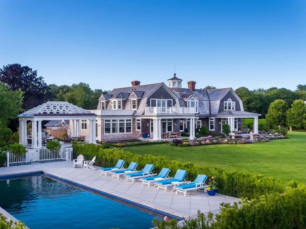 Pool terrace and coastal home with planted borders.